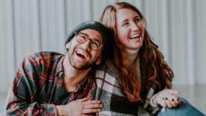 smiling woman and man sitting on floor