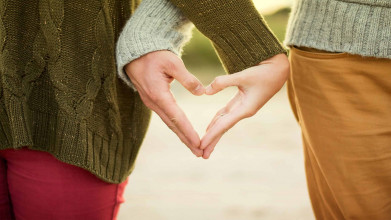 couple making a heart shape with hands