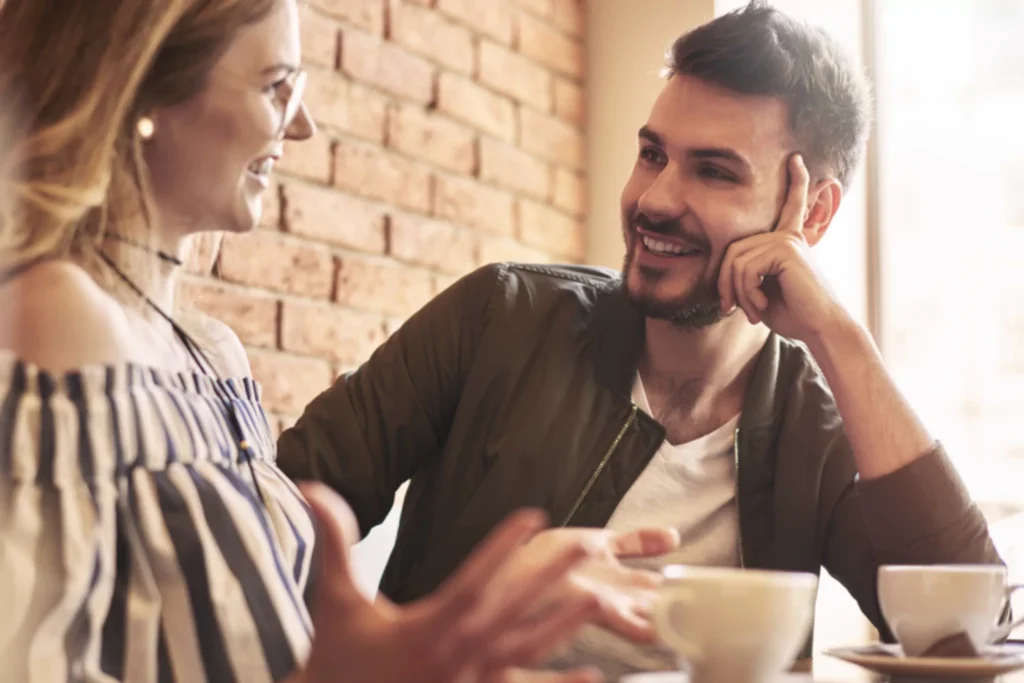 A couple sitting at a cafe table, communicating in order to restore the romance in their marriage.