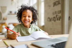 Little girl with a huge smile homeschooling