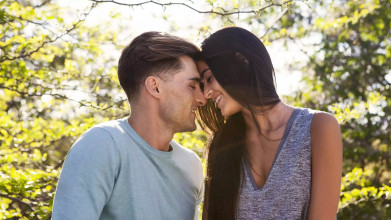 A couple leans their foreheads together, smiling and sharing an intimate moment, symbolizing the idea of how to protect your marriage by putting a hedge around your marriage, creating a strong, protective emotional bond.