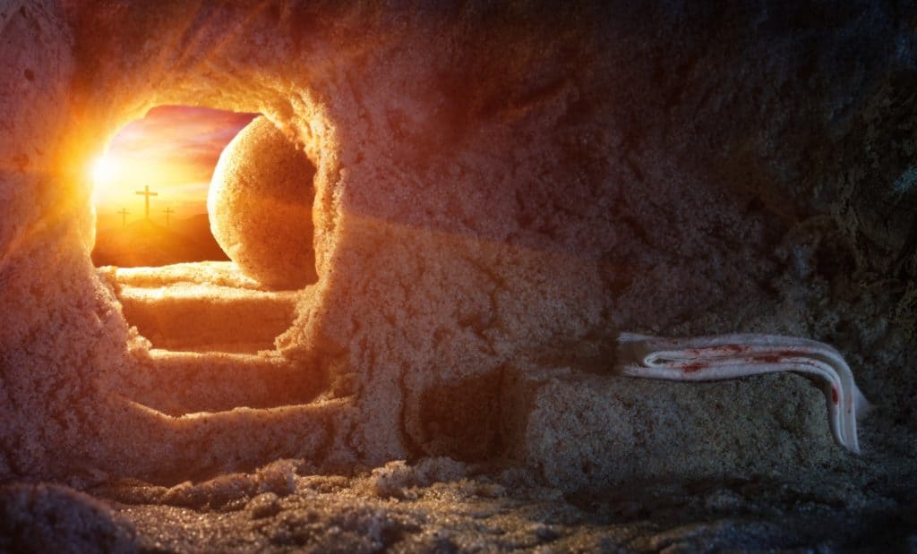 Illustration of Christ’s empty tomb, shown from the inside, looking out the opening to His cross with the sunrise behind