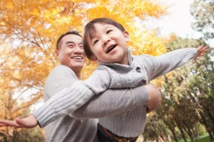 You can transform from fearful to fearless as a parent- The young boy has his arms out as if he was an airplane