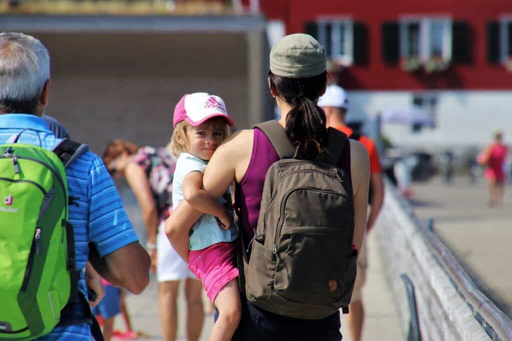 back of babysitter holding child