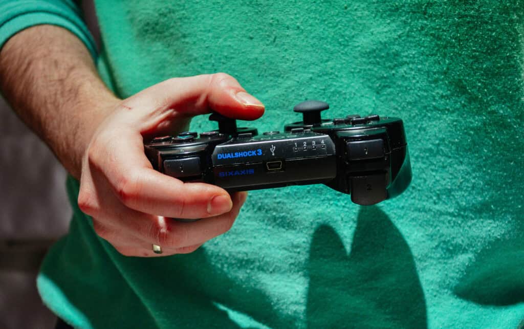 married man with wedding ring holding video game controller