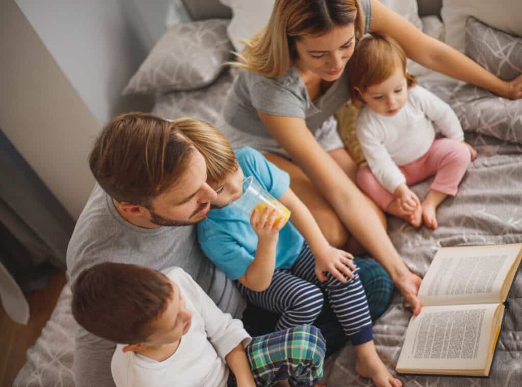 family reading together two parents three young kids