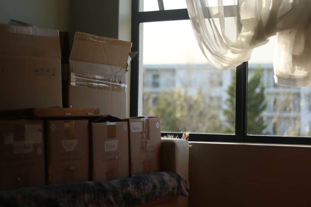 Stack of moving boxes by window