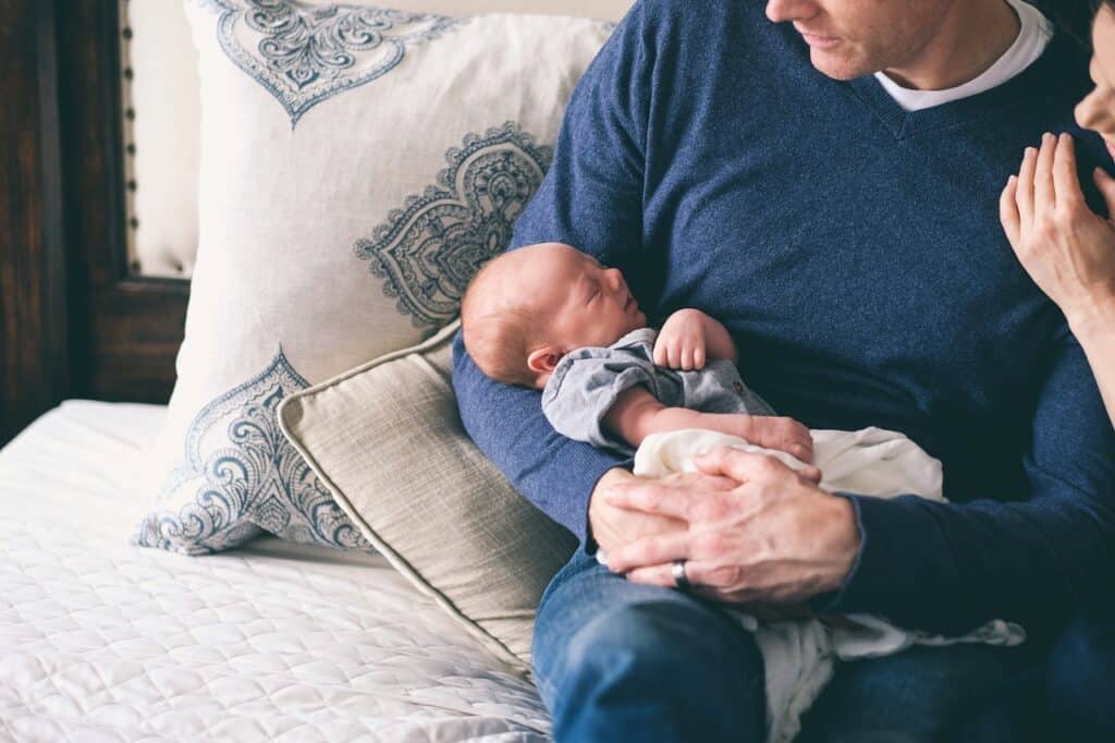 man holding newborn child