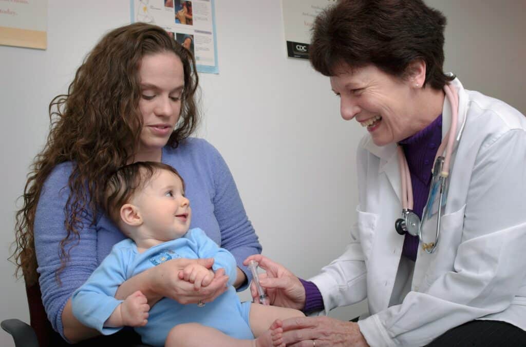 mom and baby with smiling doctor