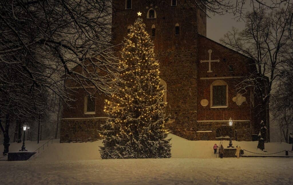 Christmas tree lit up in front of church