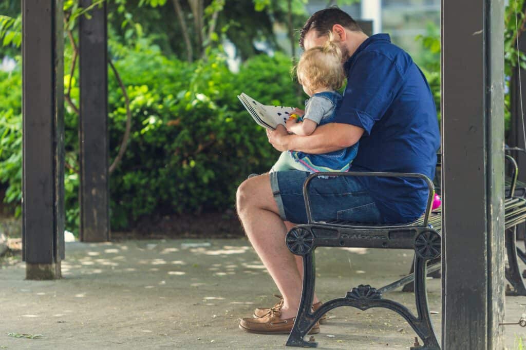 dad reading to baby girl
