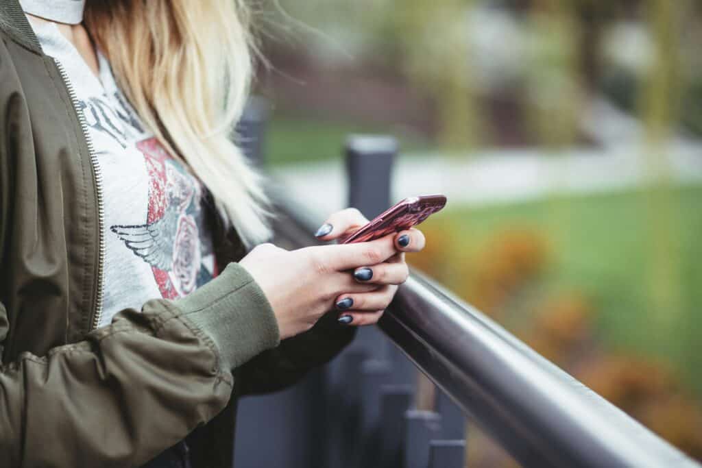 hands of teen girl on phone