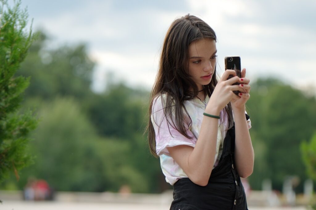 teen girl looking on phone