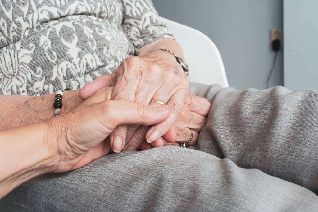 older woman hands younger hands holding them