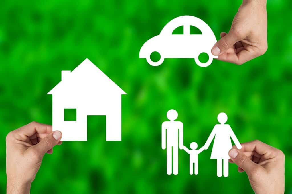 Hands holding Images of car, house, family on green background