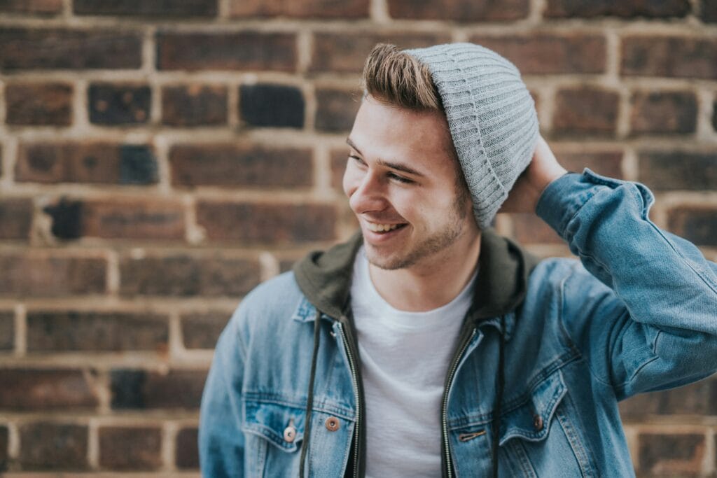 teen guy in beanie smiling