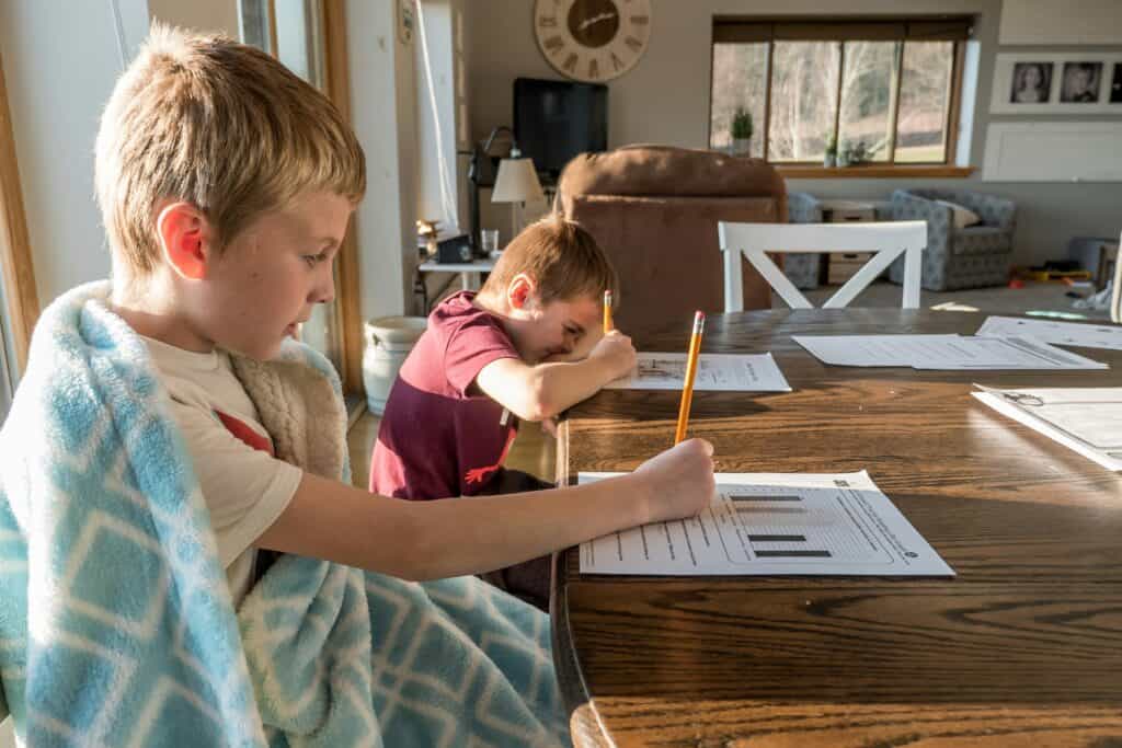 kids homeschooling at table