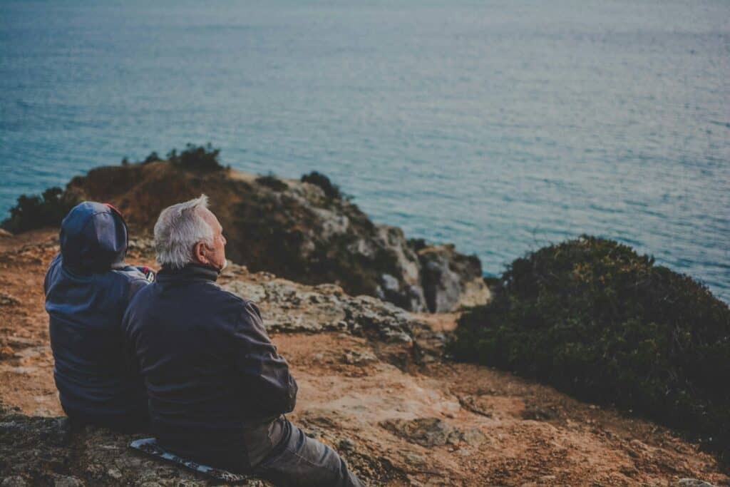 older man and woman looking out over ocean