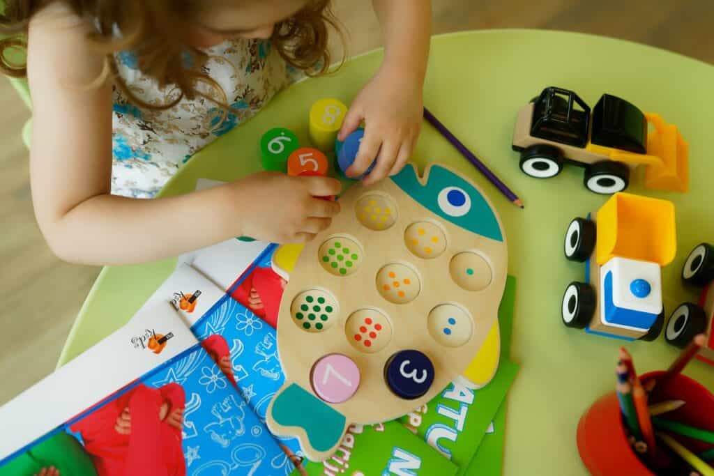 little girl playing with learning toys