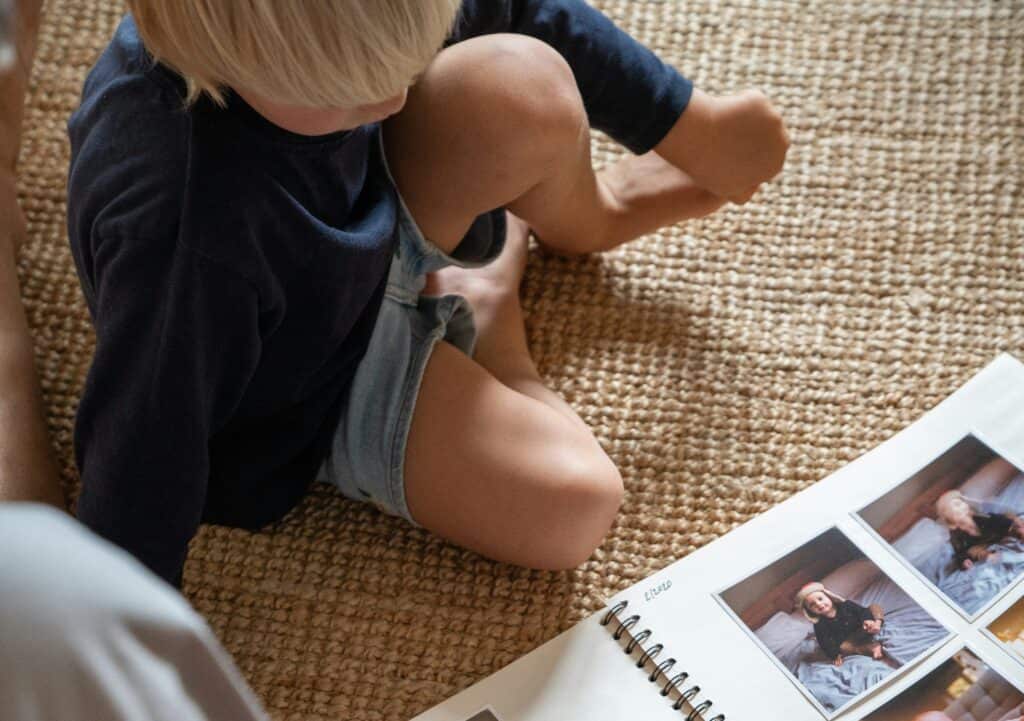 boy looking at scrapbook