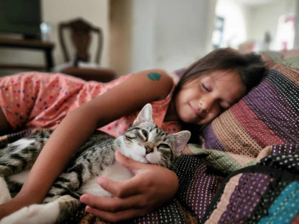 girl sleeping with cat