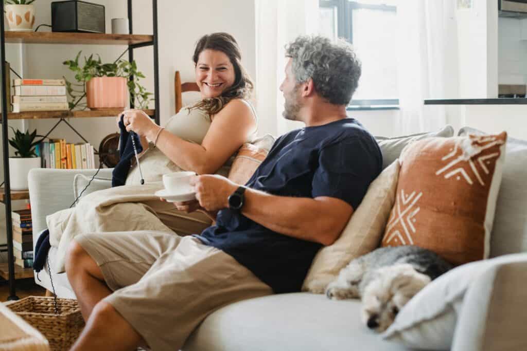 couple on couch woman knitting pregnant