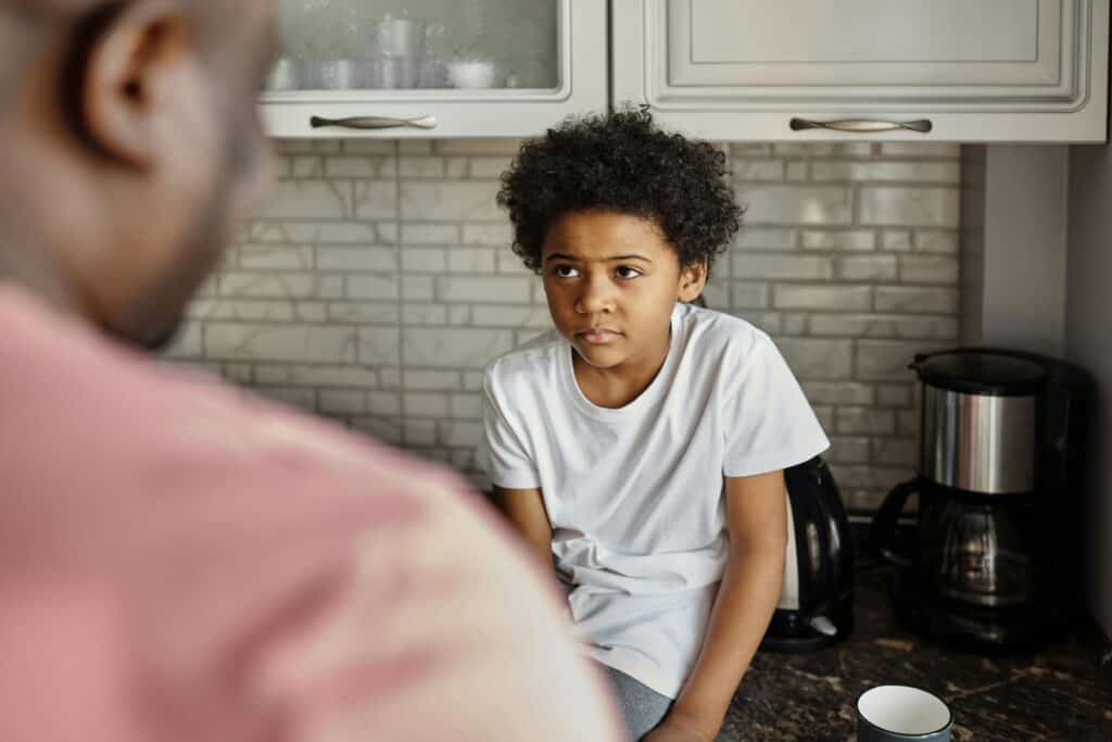 boy listening while dad in foreground talks to him