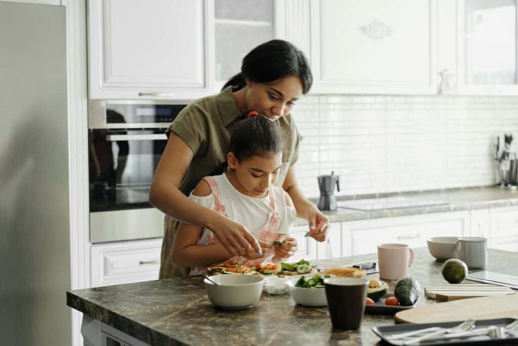 mom and daughter making healthy sandwich together