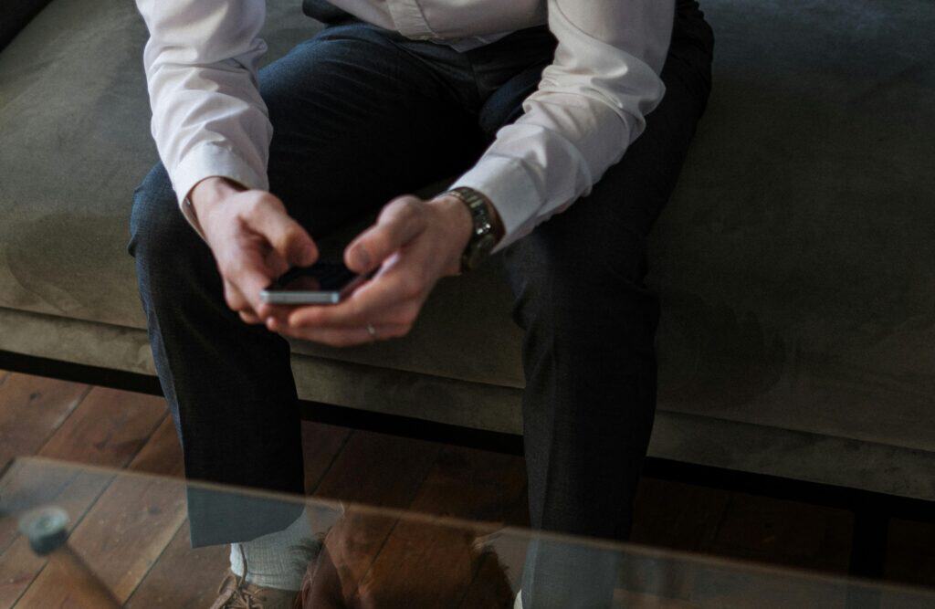 Hands of married man looking at his cell phone