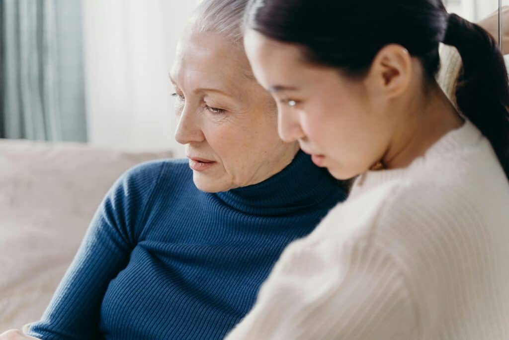 mom and adult daughter looking at something together