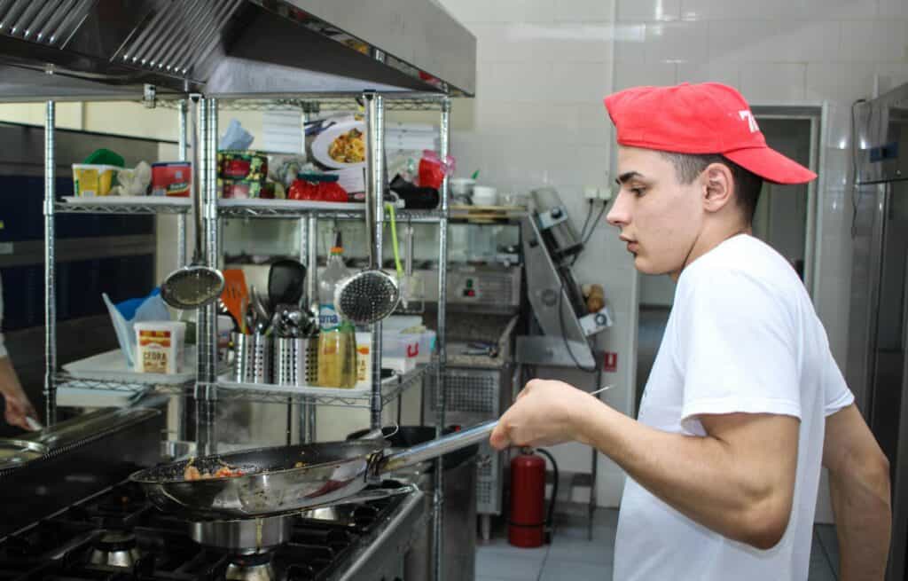teen cooking in restaurant job