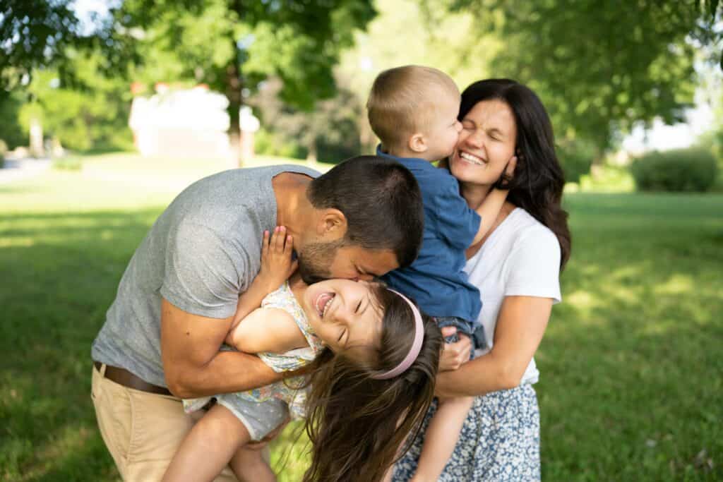 kids and parents hugging laughing