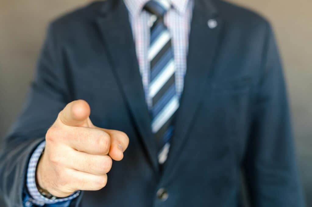man in suit finger pointing