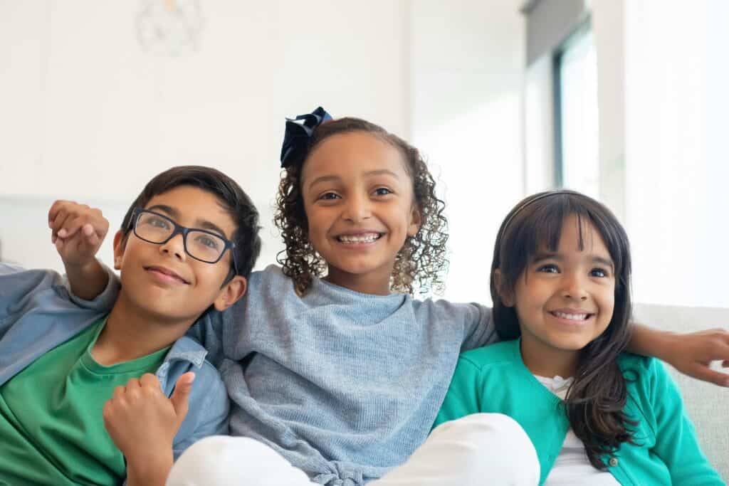 Three siblings smiling