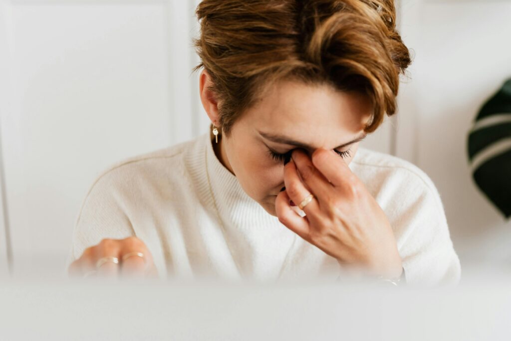 woman hands to eyes crying upset