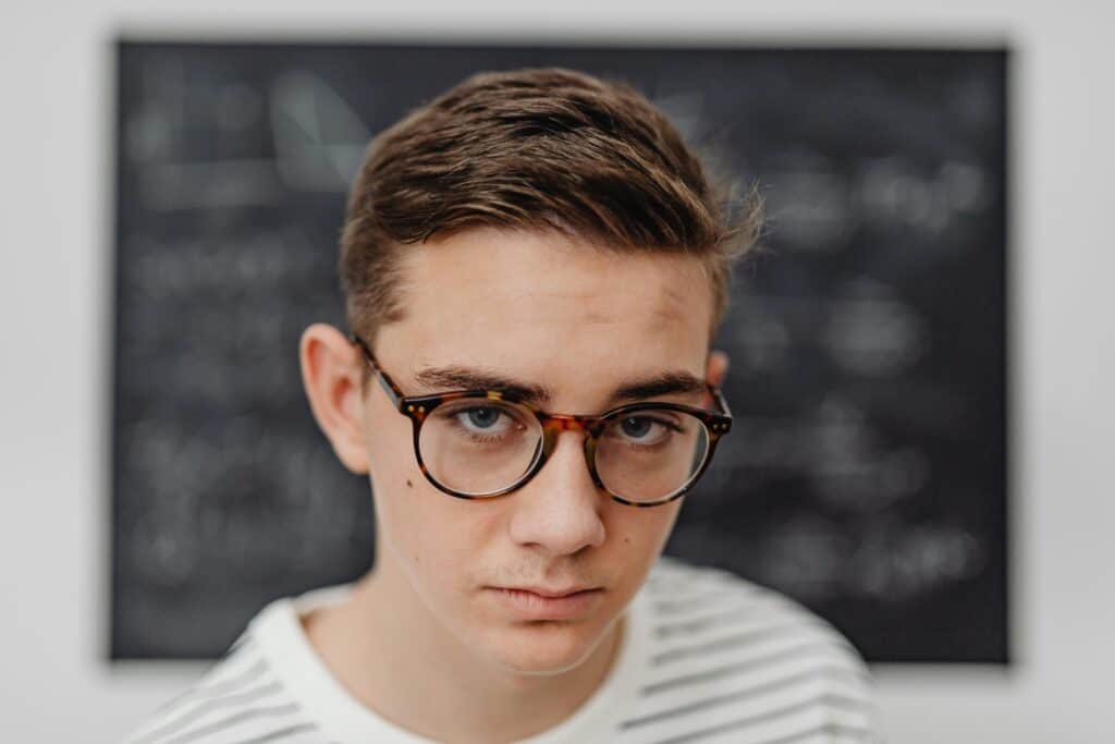 teen guy looking unhappy glasses