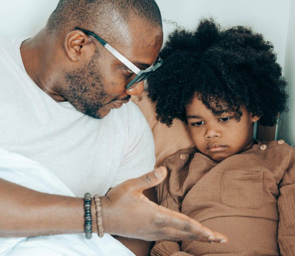 Dad talking to sad or angry child