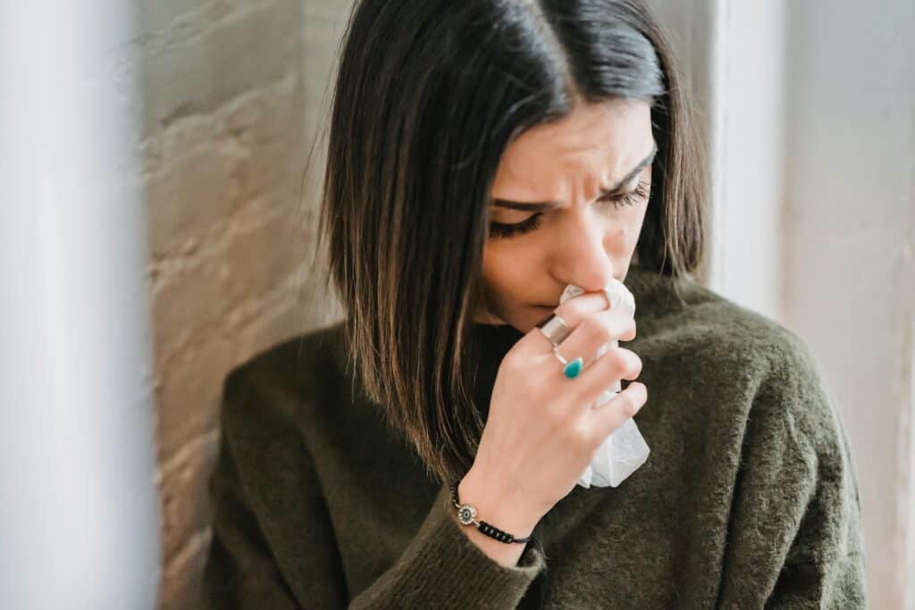 woman crying holding tissue