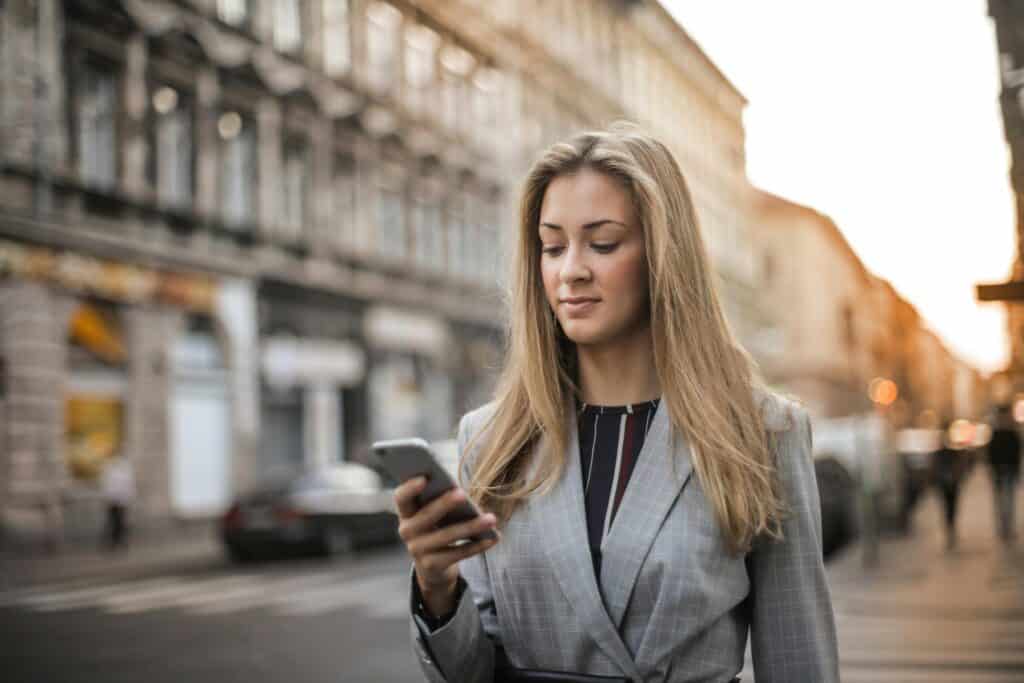 business woman looking at phone text