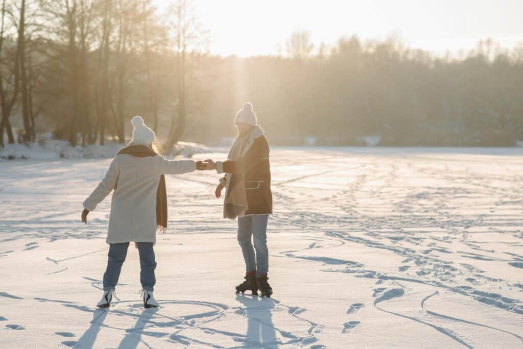 couple ice skating on pond