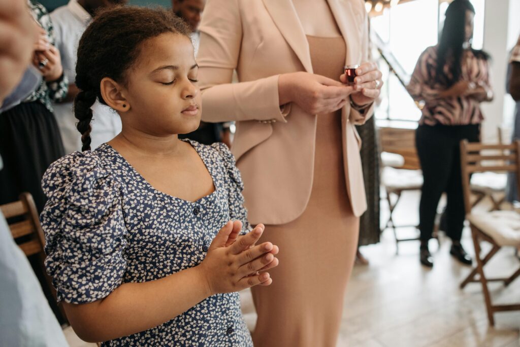 little girl praying in church