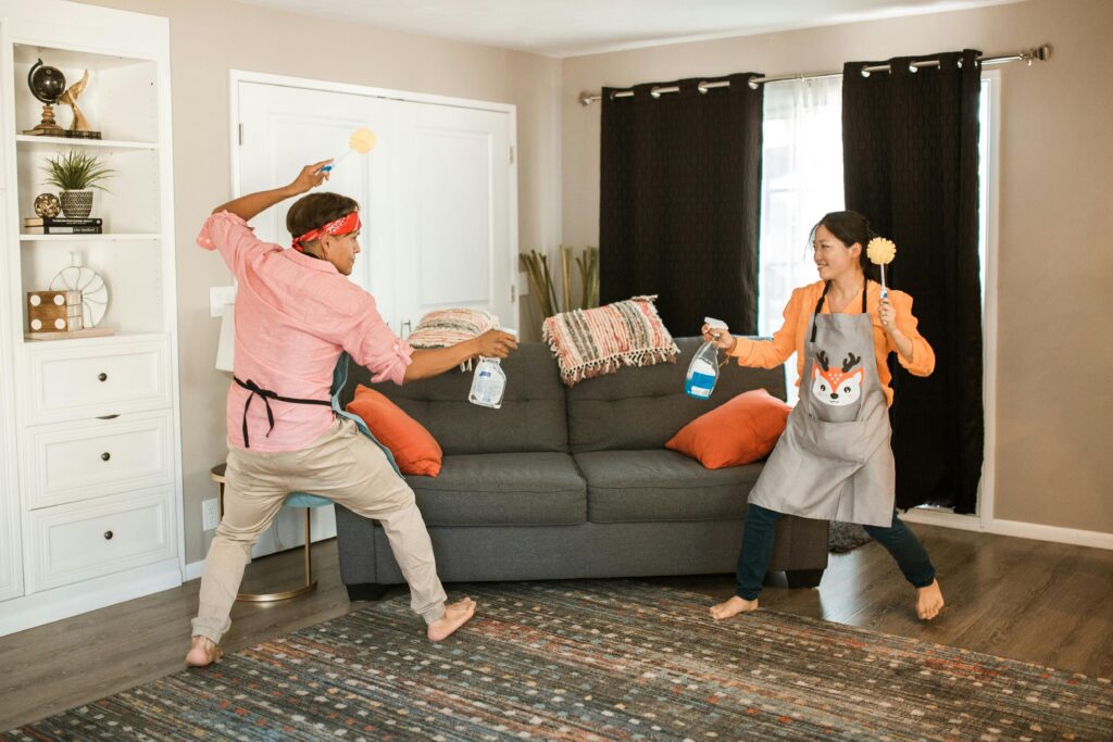 couple having toilet brush fight cleaning