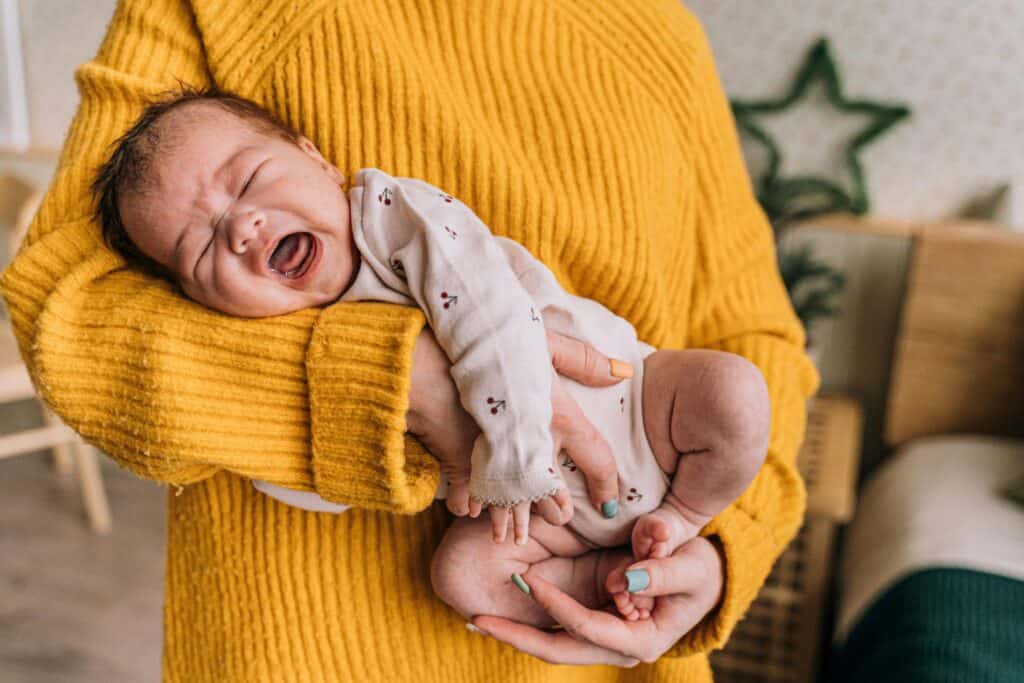 woman holding crying baby