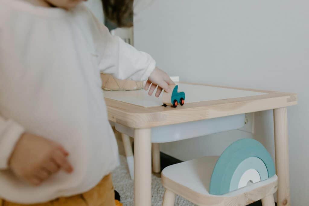 hand of preschooler touching or taking toy
