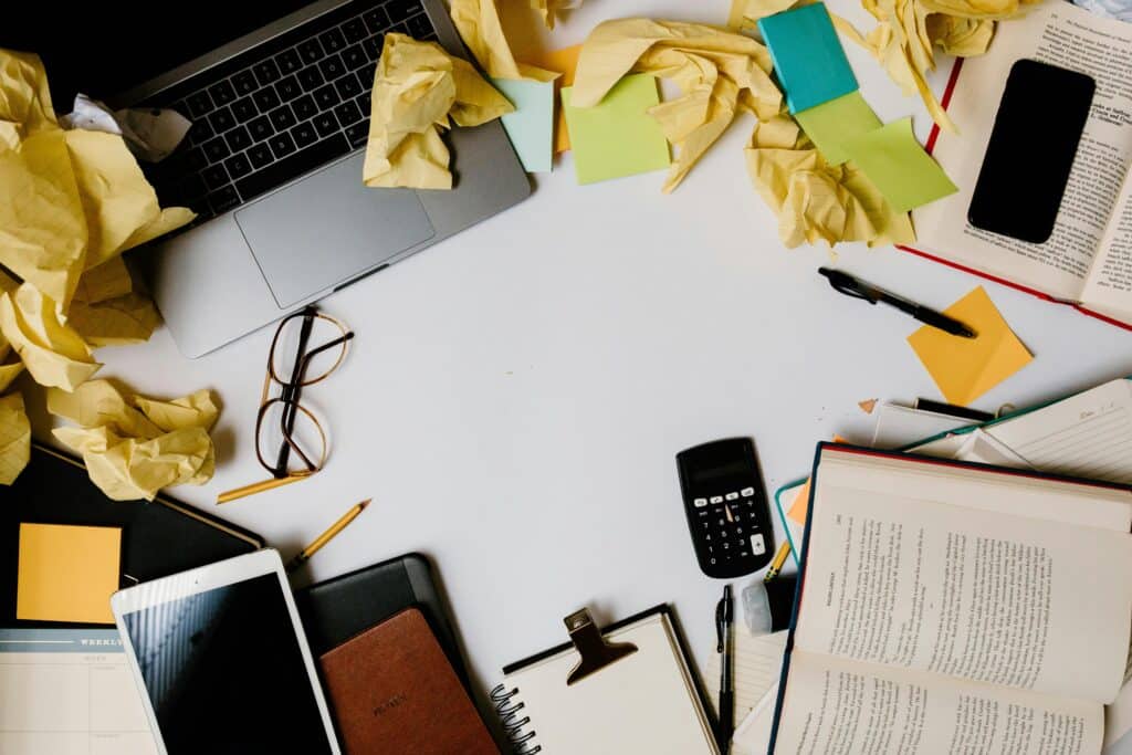 messy desk with papers and items strewn around