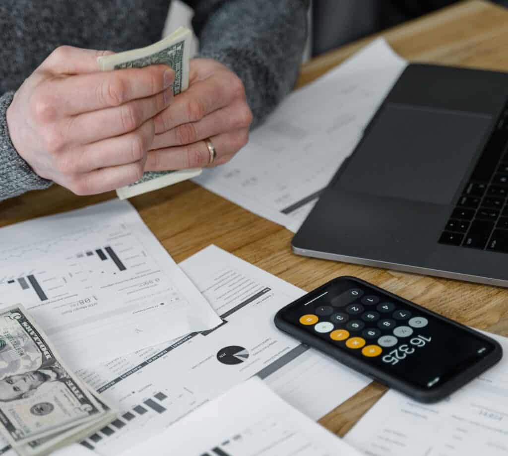man with calculator money computer financial planning