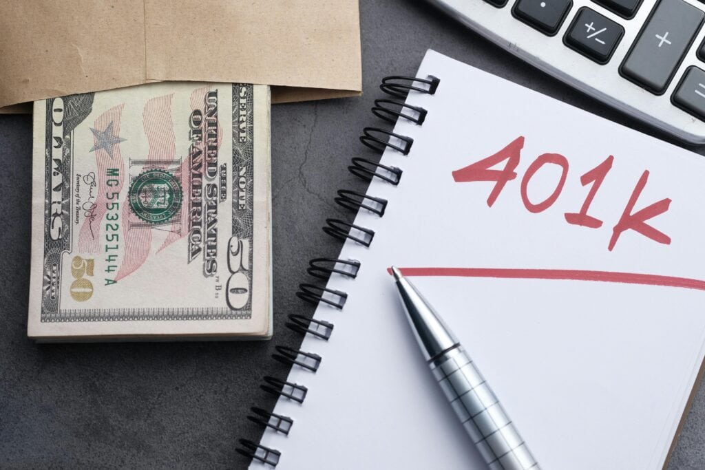 picture of cash, calculator, paper that says 401k