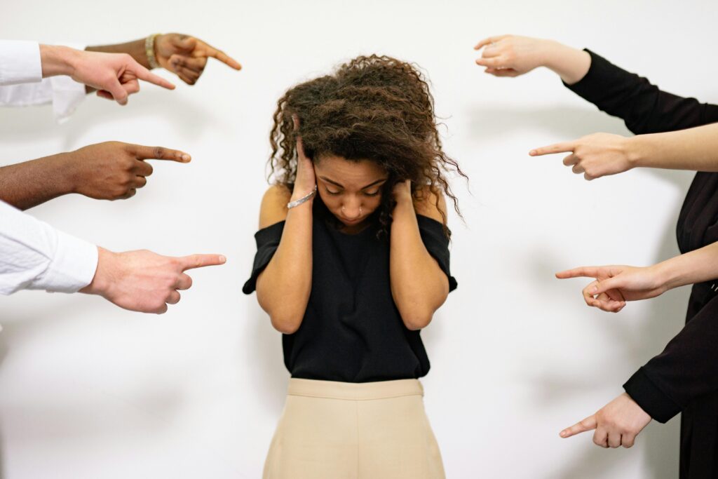 woman holding her head fingers pointing from both sides