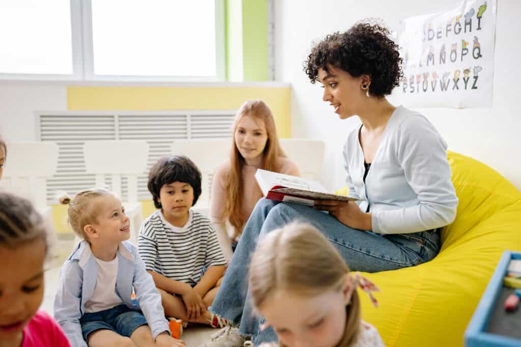 teachers and preschool students reading