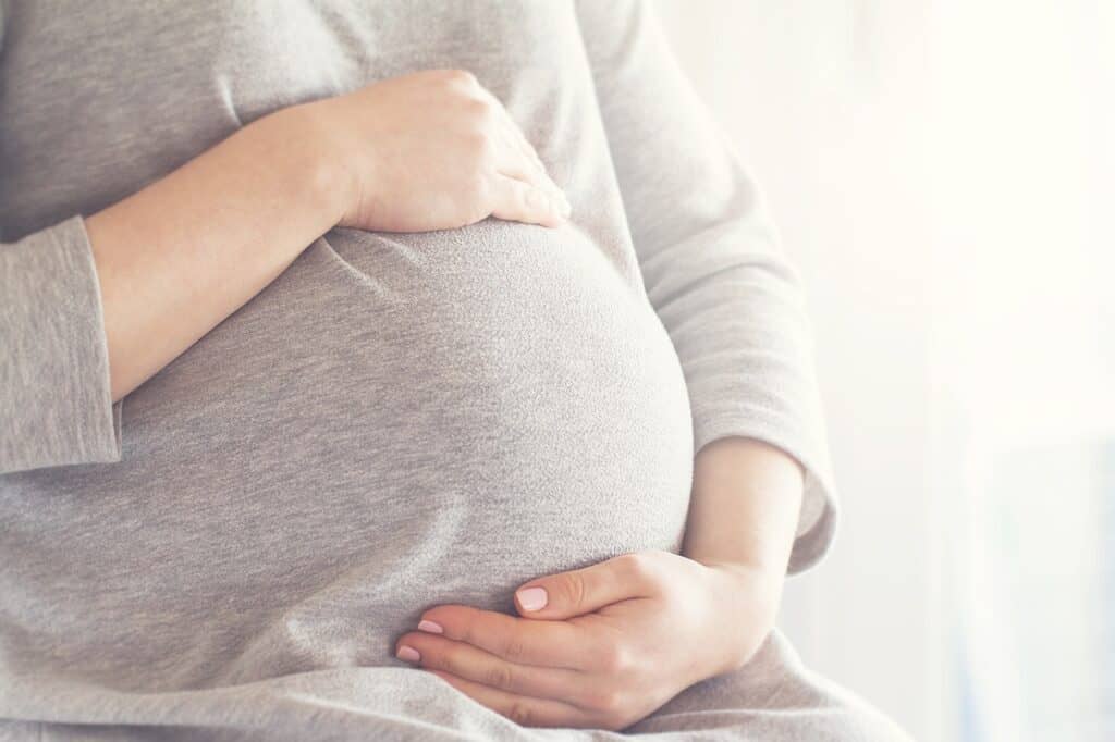 woman holding pregnant belly